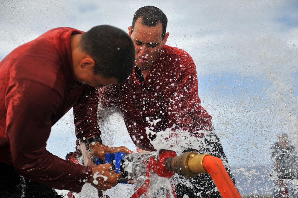 U.S. Navy Aviation Boatswain's Mate Airman Jimmy Pone, left, and Aviation Boatswain's Mate 1st Class Toby Shoemaker use a soft patch to repair a simulated burst pipe during a damage control competition aboard the aircraft carrier USS Abraham Lincoln (CVN 72) in the Pacific Ocean March 6. The competition between teams of Sailors was designed to test their abilities to respond to various at-sea mishaps and emergency scenarios. The Abraham Lincoln Carrier Strike Group was under way on a scheduled deployment to the U.S. 5th and 7th Fleet areas of responsibility. (U.S. Navy photo by Mass Communication Specialist 3rd Class Spencer Mickler/Released)